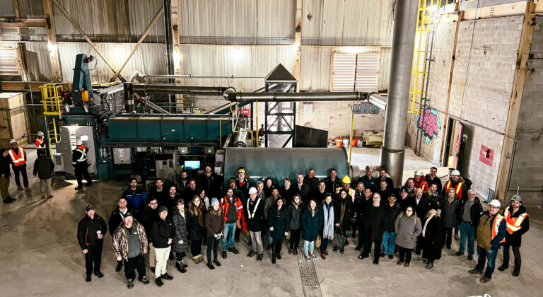 Group of 55 people standing in front of a pyrolysis unit